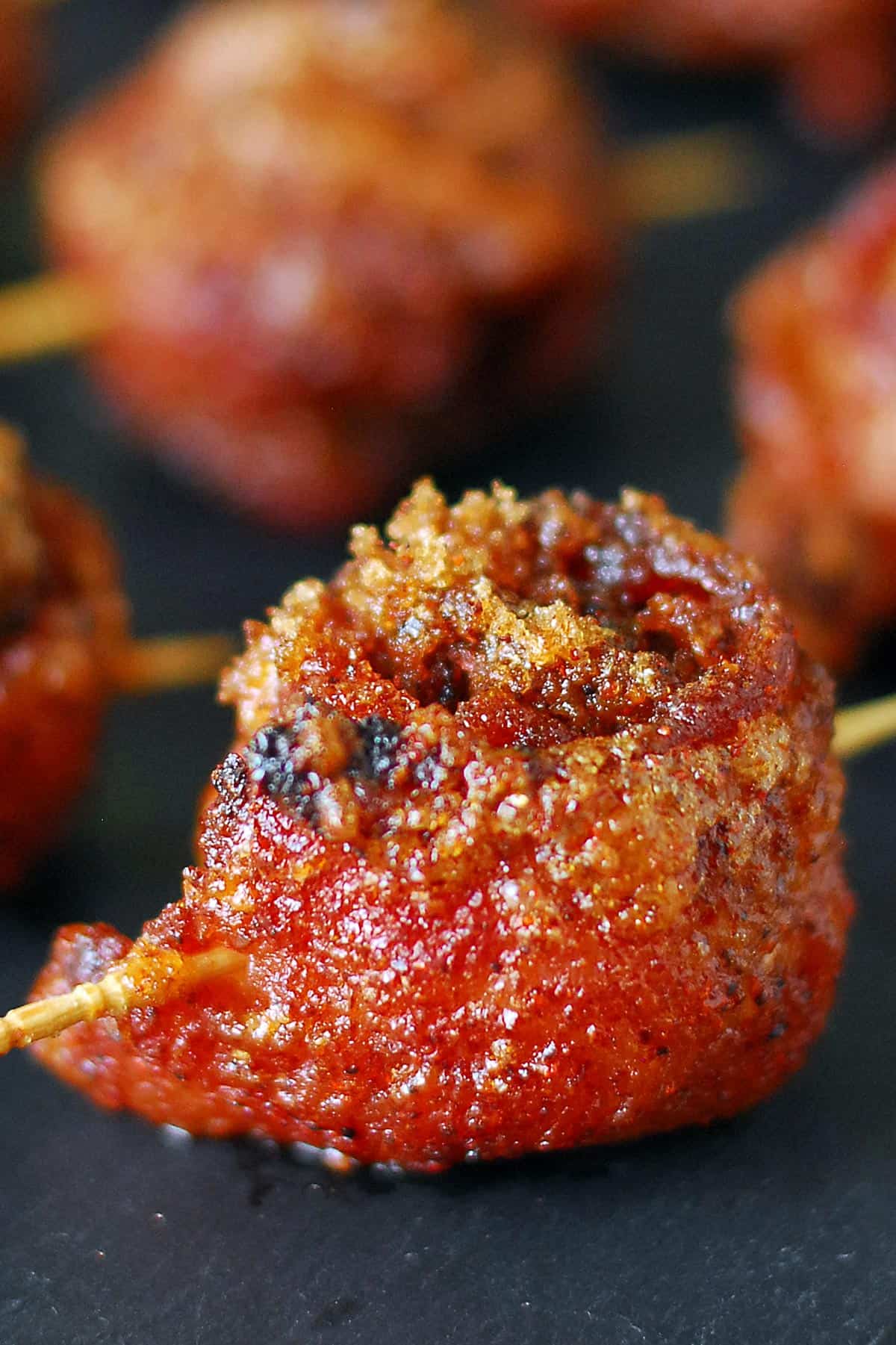 Sweet and spicy bacon wrapped meatballs.