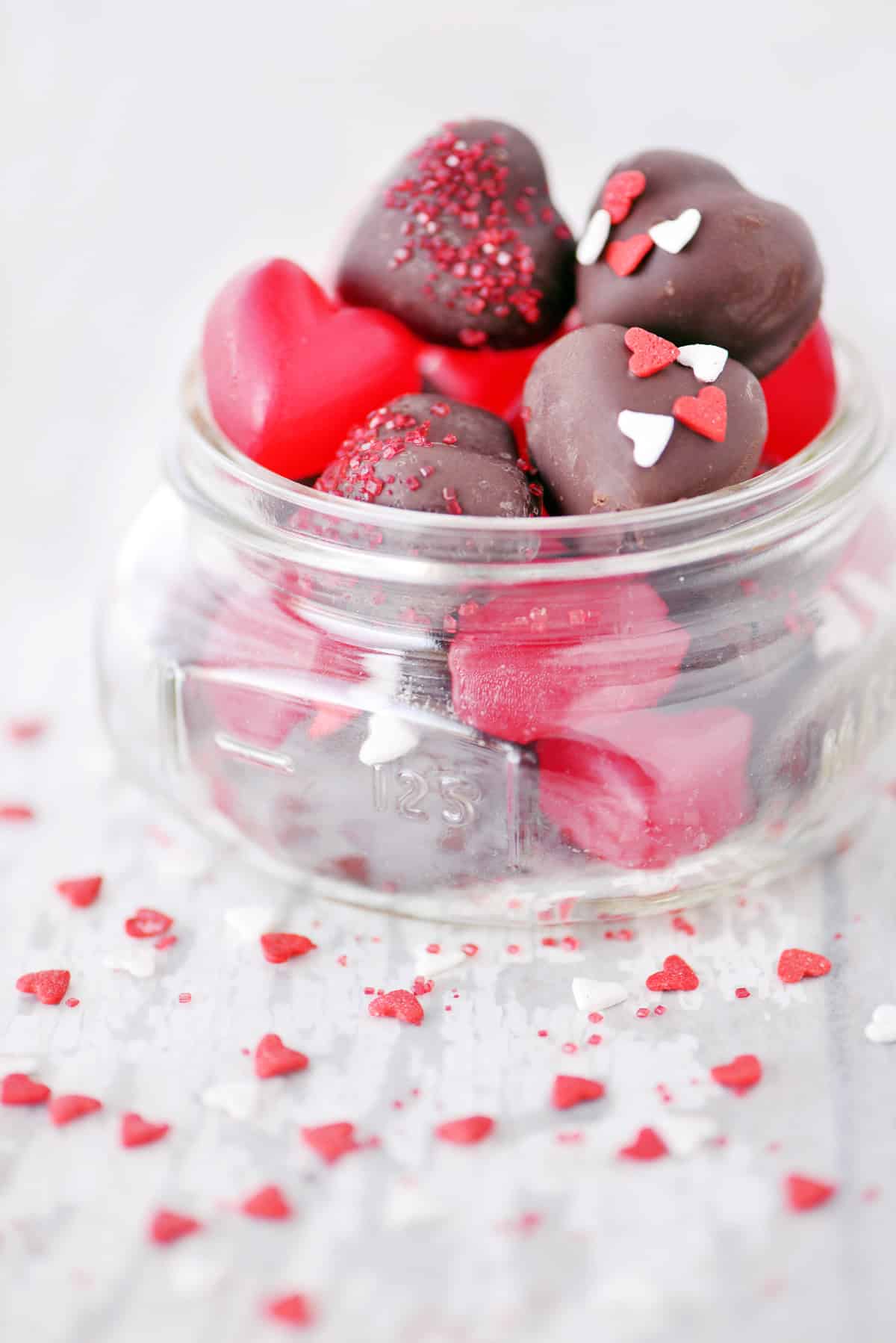 Chocolate covered cherry hearts in a jar.