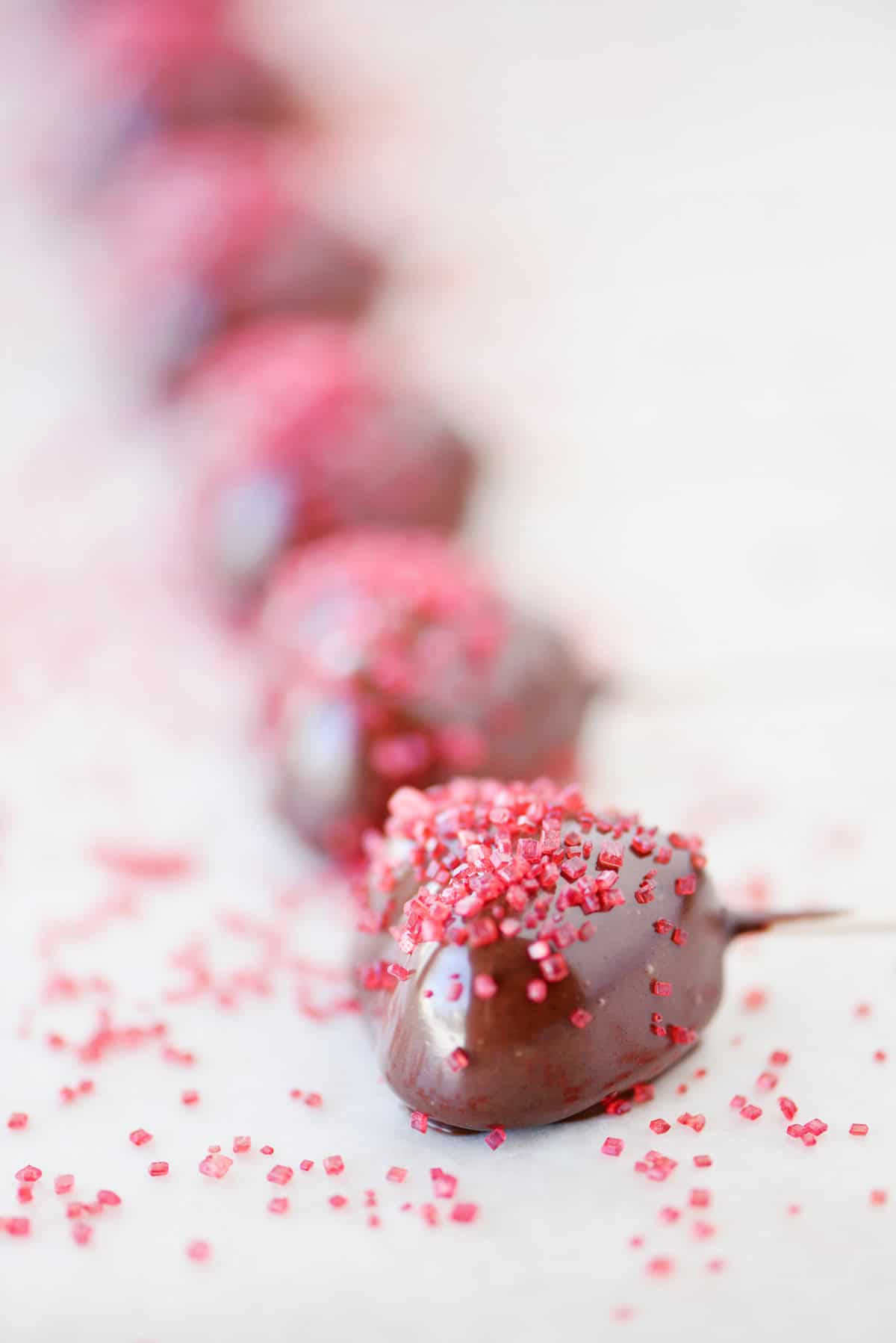 Chocolate gummy hearts with sprinkles.