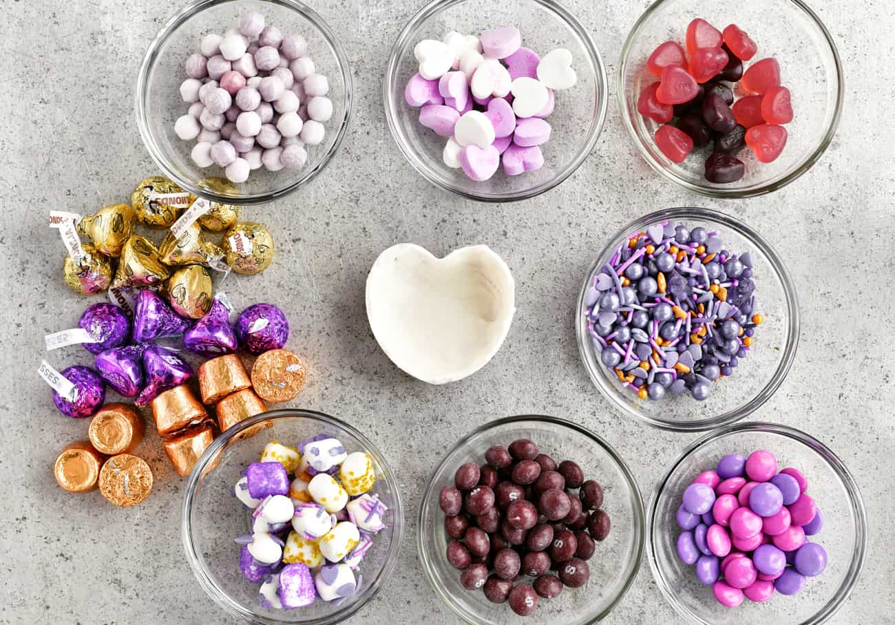 purple and gold candies in bowls