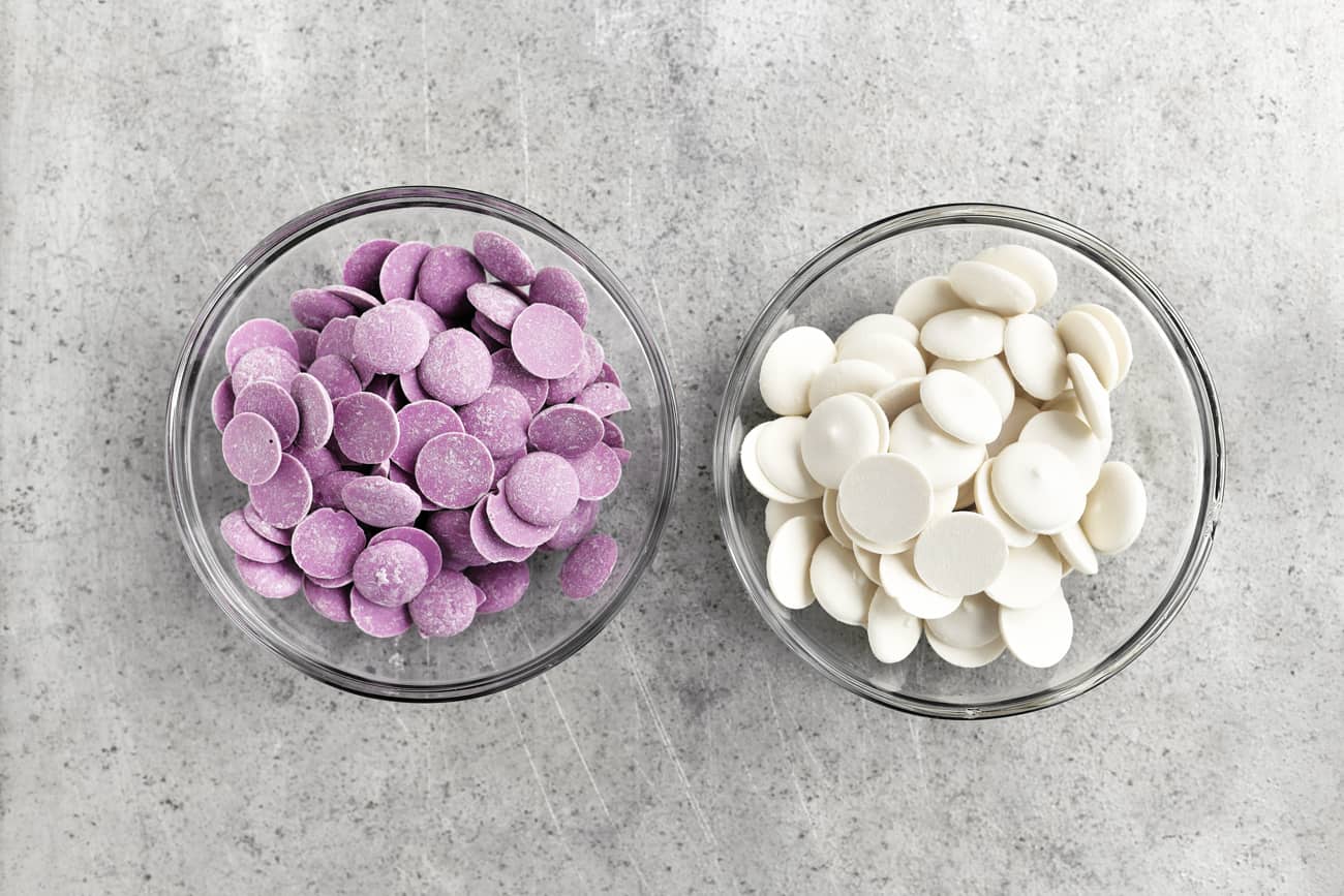 purple and white candy wafers in bowls