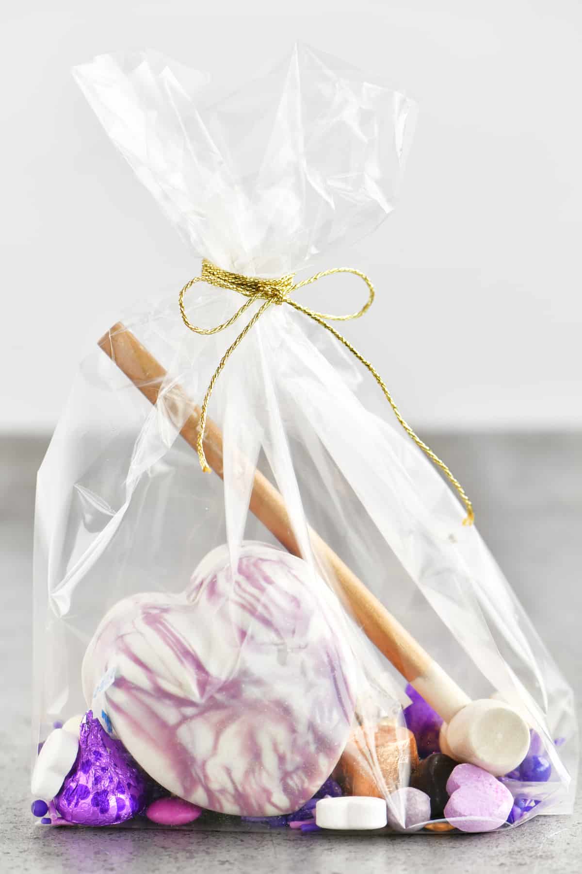 purple and white swirled breakable chocolate heart in a gift bag