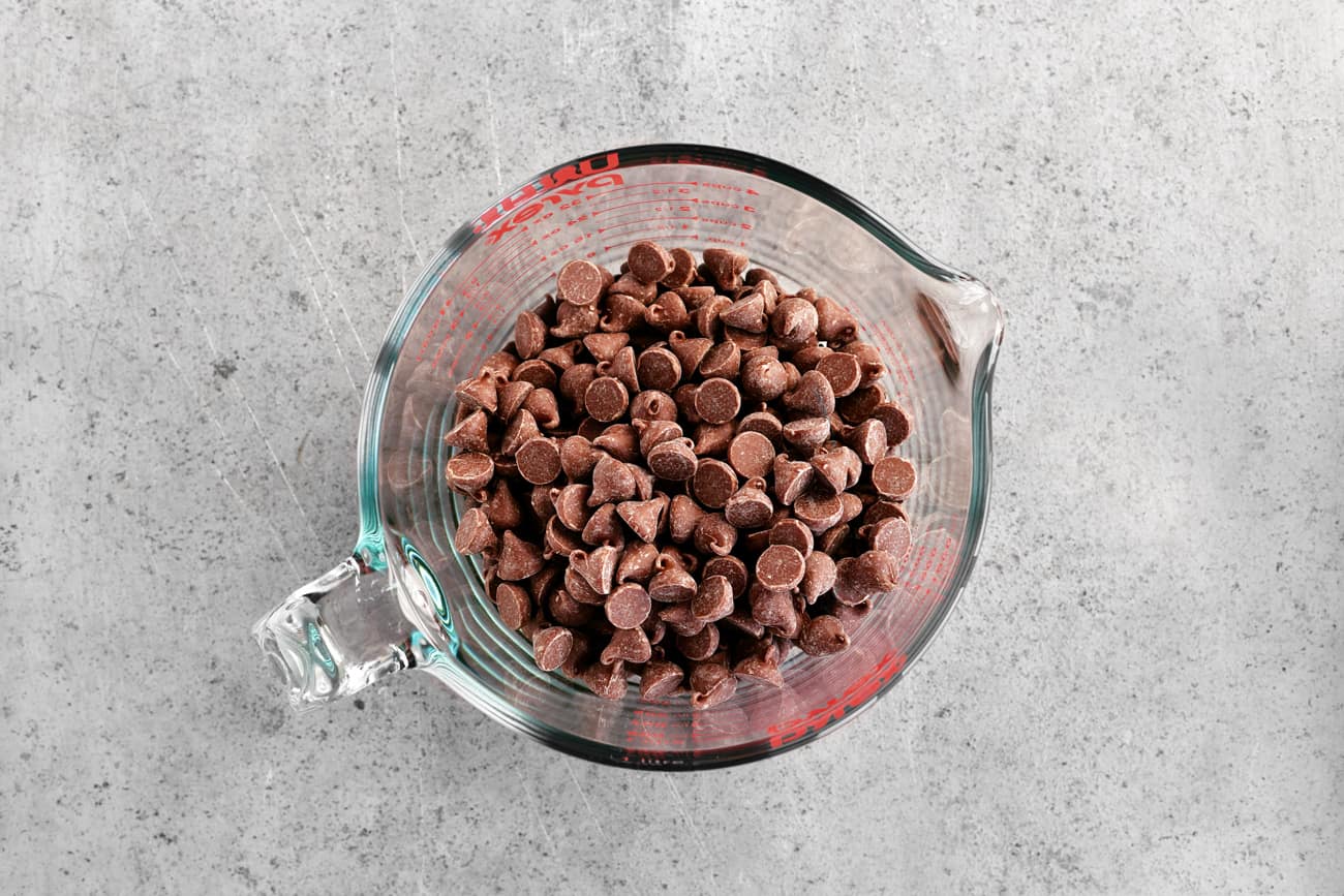 Chocolate chips in a glass mixing bowl.
