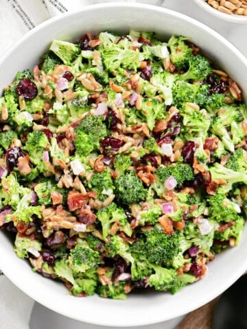 a bowl of brocolli salad on a counter