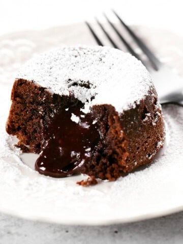 a small cake on a small plate with a fork.