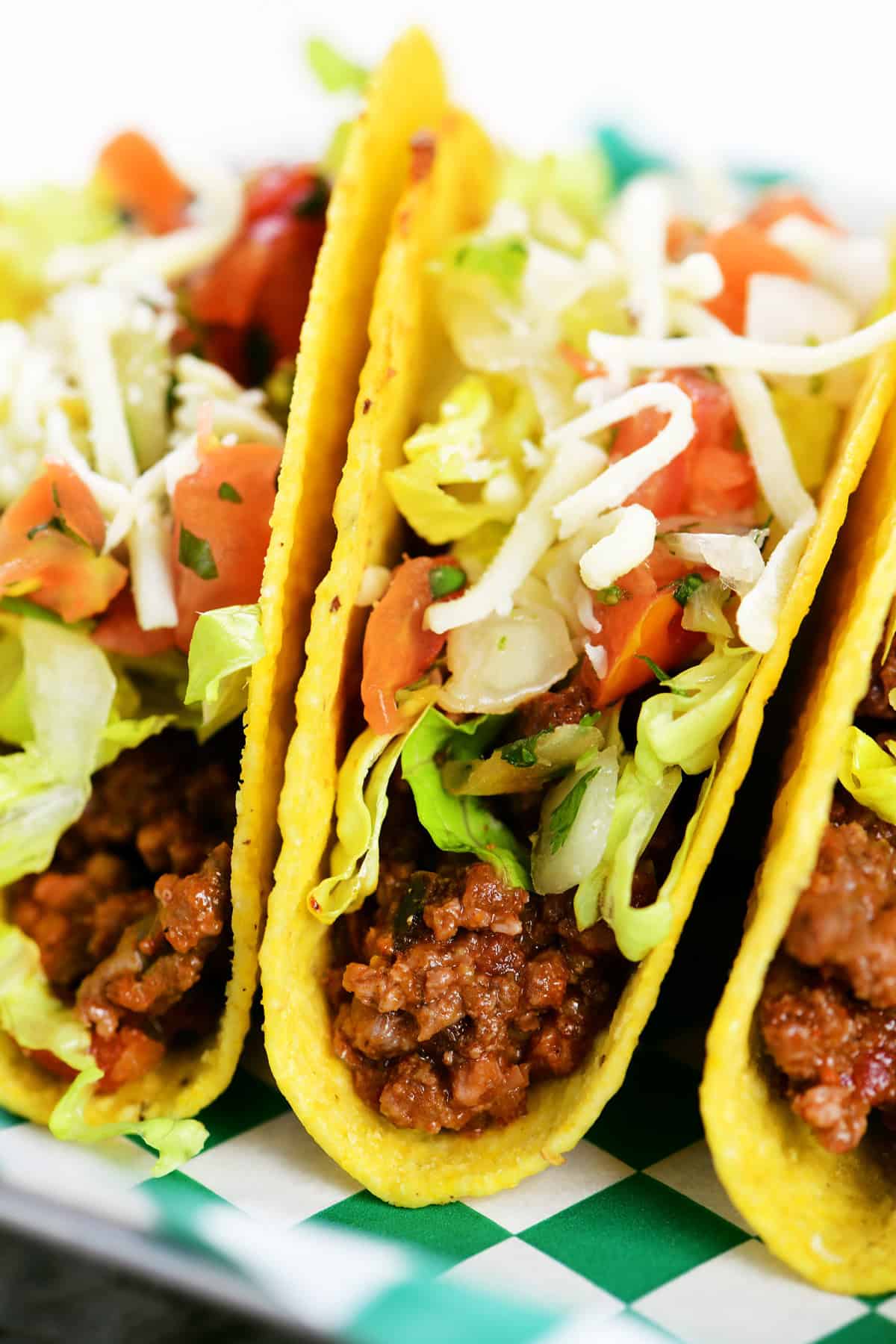 Slow cooker taco in a hard shell with toppings.