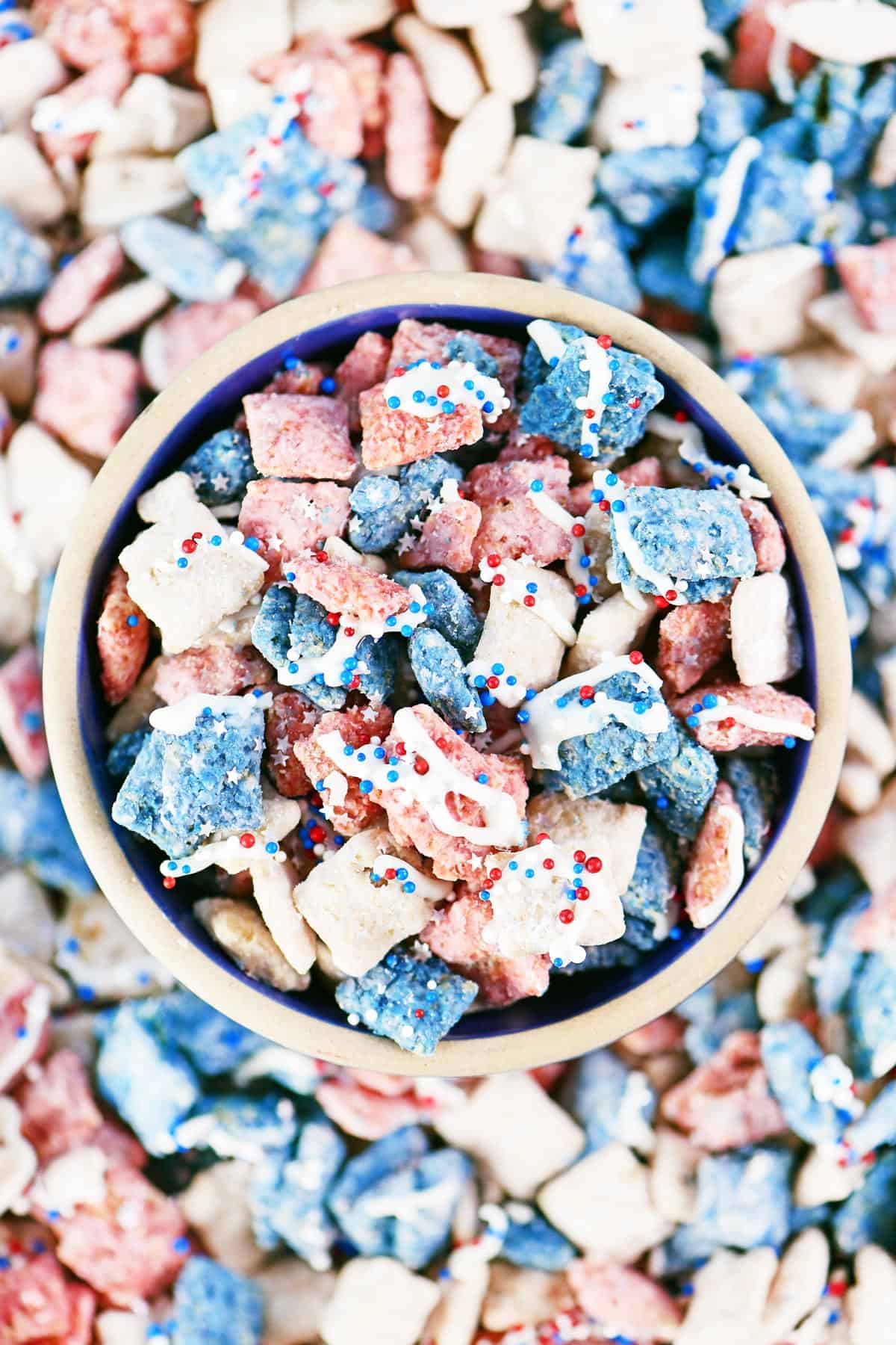A bowl of red, white and blue puppy chow muddy buddies.