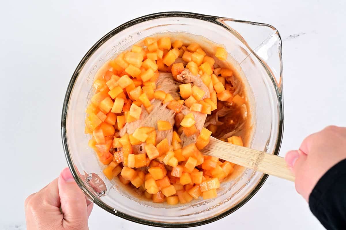 Fold diced peaches into the batter.