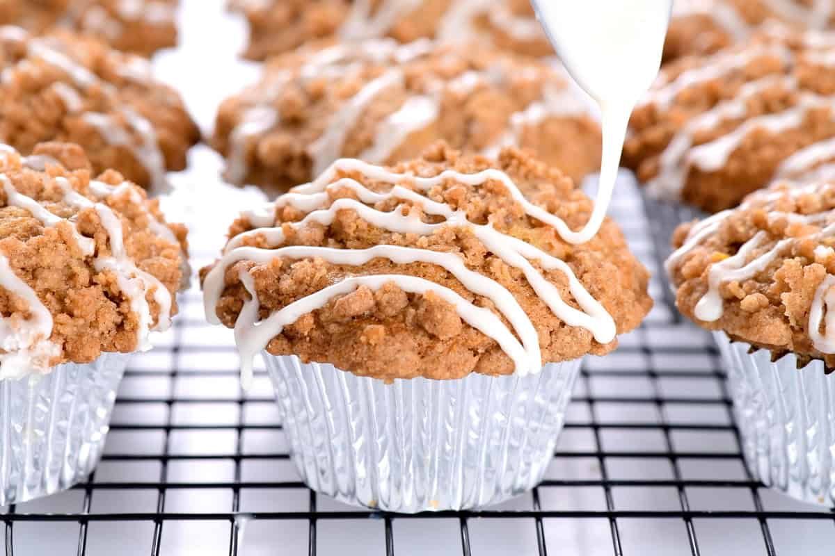 Drizzling powdered sugar glaze on top.