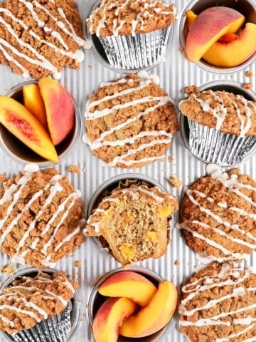 Peach muffins and sliced peaches in a muffin pan.