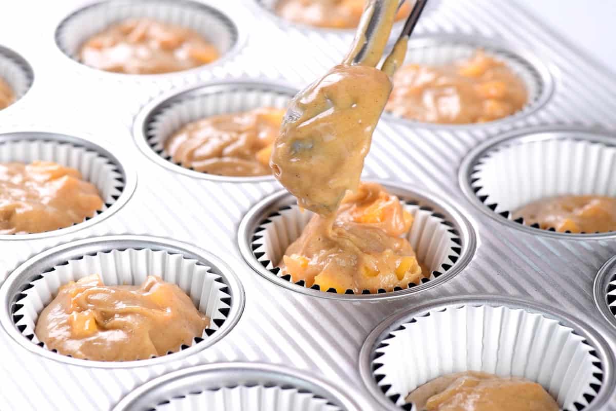 Scooping batter into the pan.