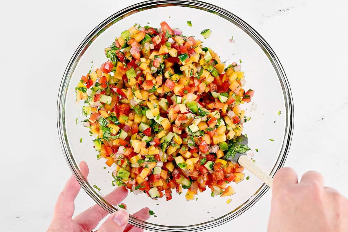 Stirring peach salsa.