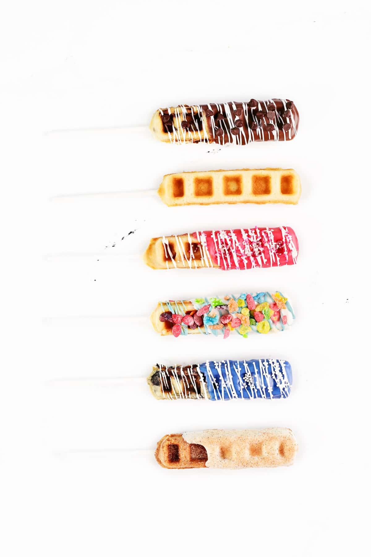 Six decorated waffle pops with toppings.