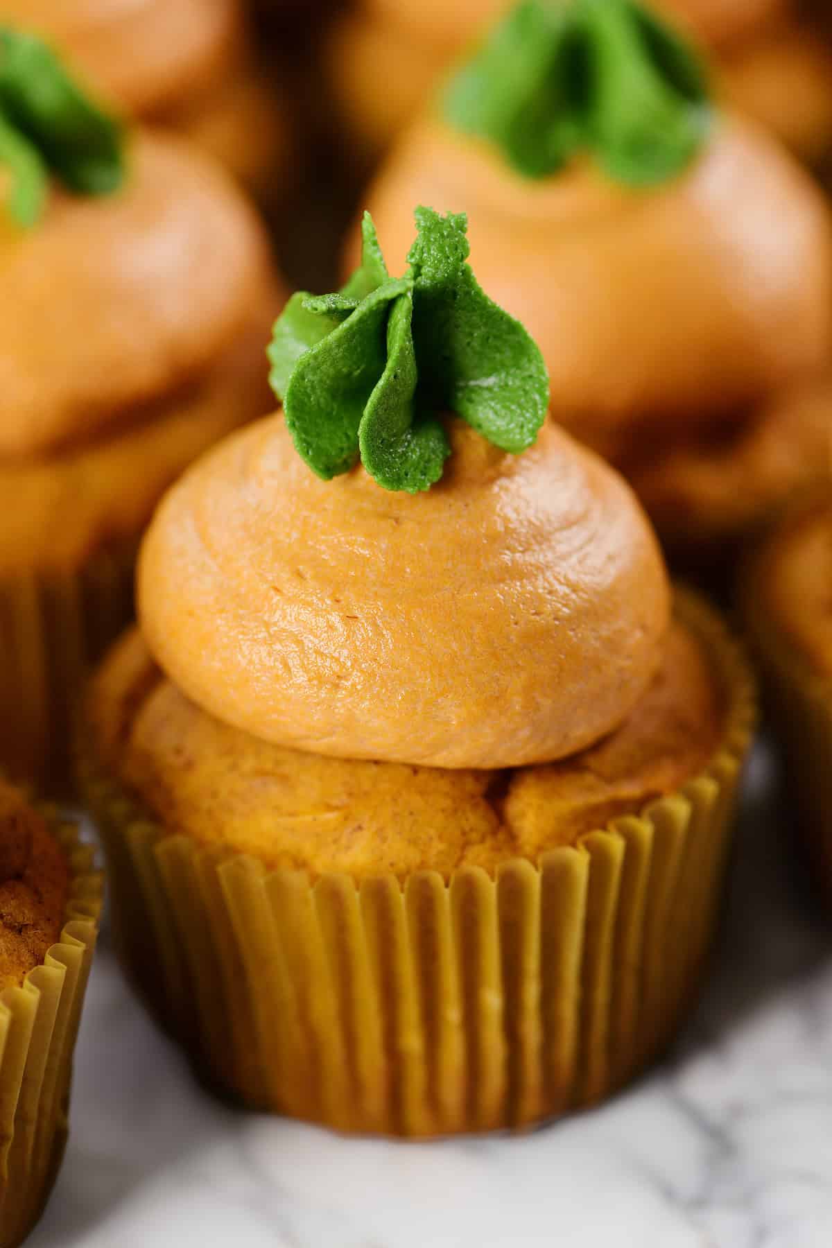 Pumpkin cupcakes with buttercream frosting.