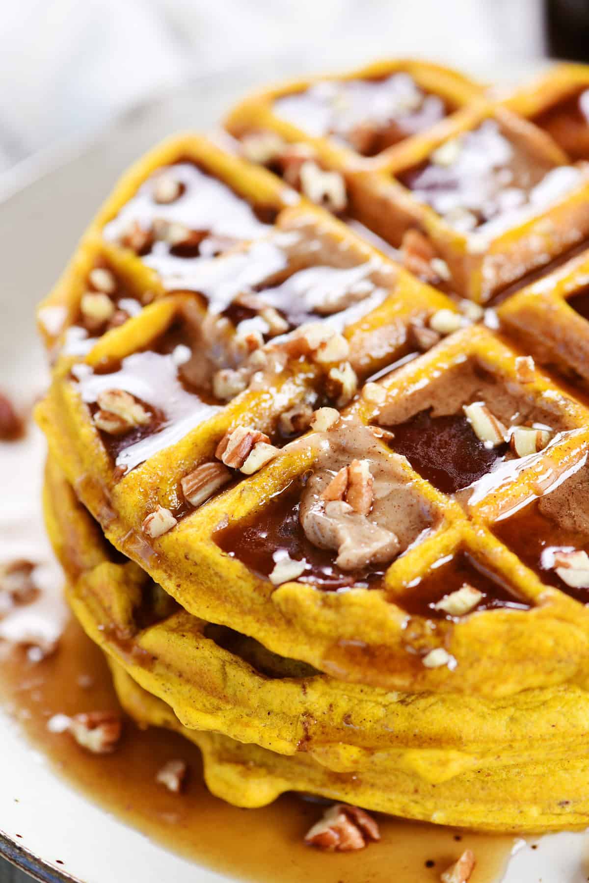 Pumpkin pecan waffles on a plate.