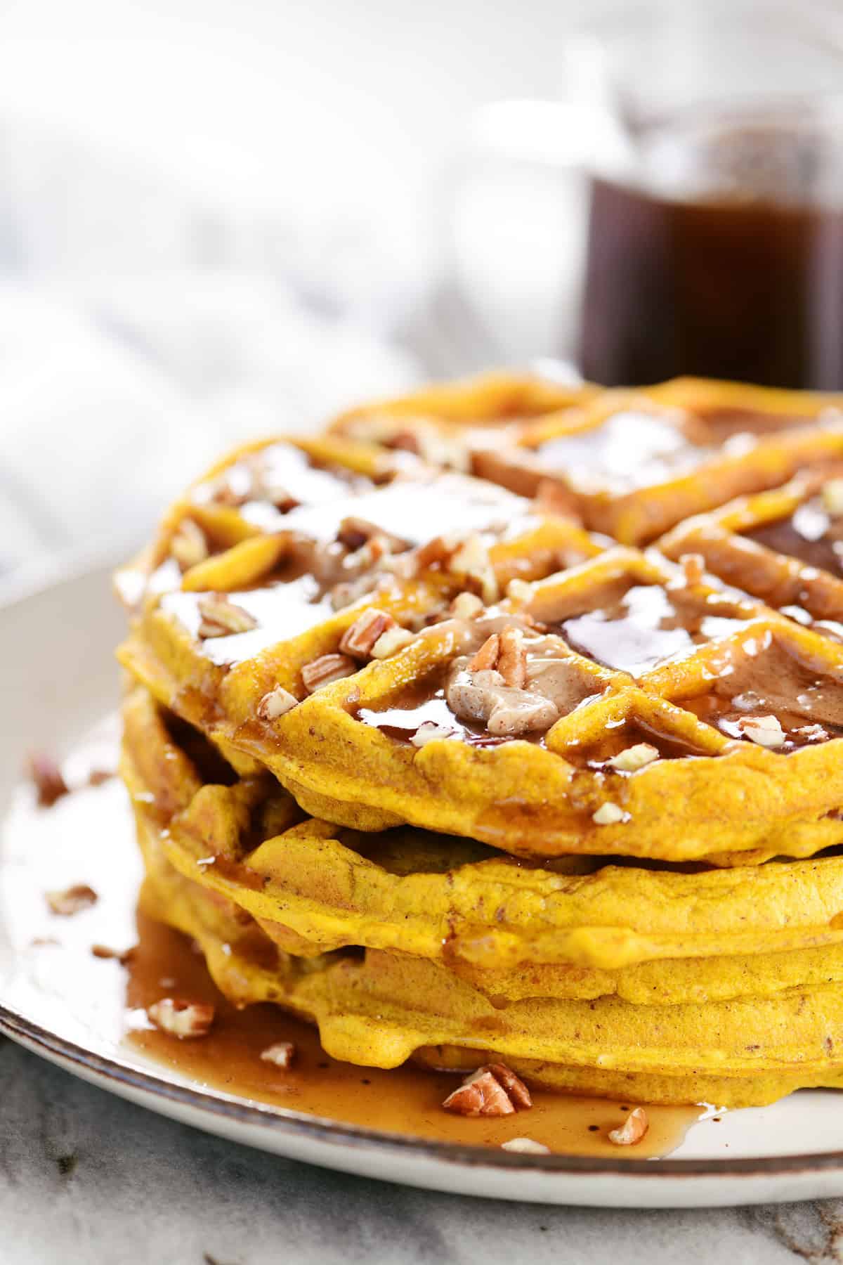 Pumpkin pecan waffles on a plate.