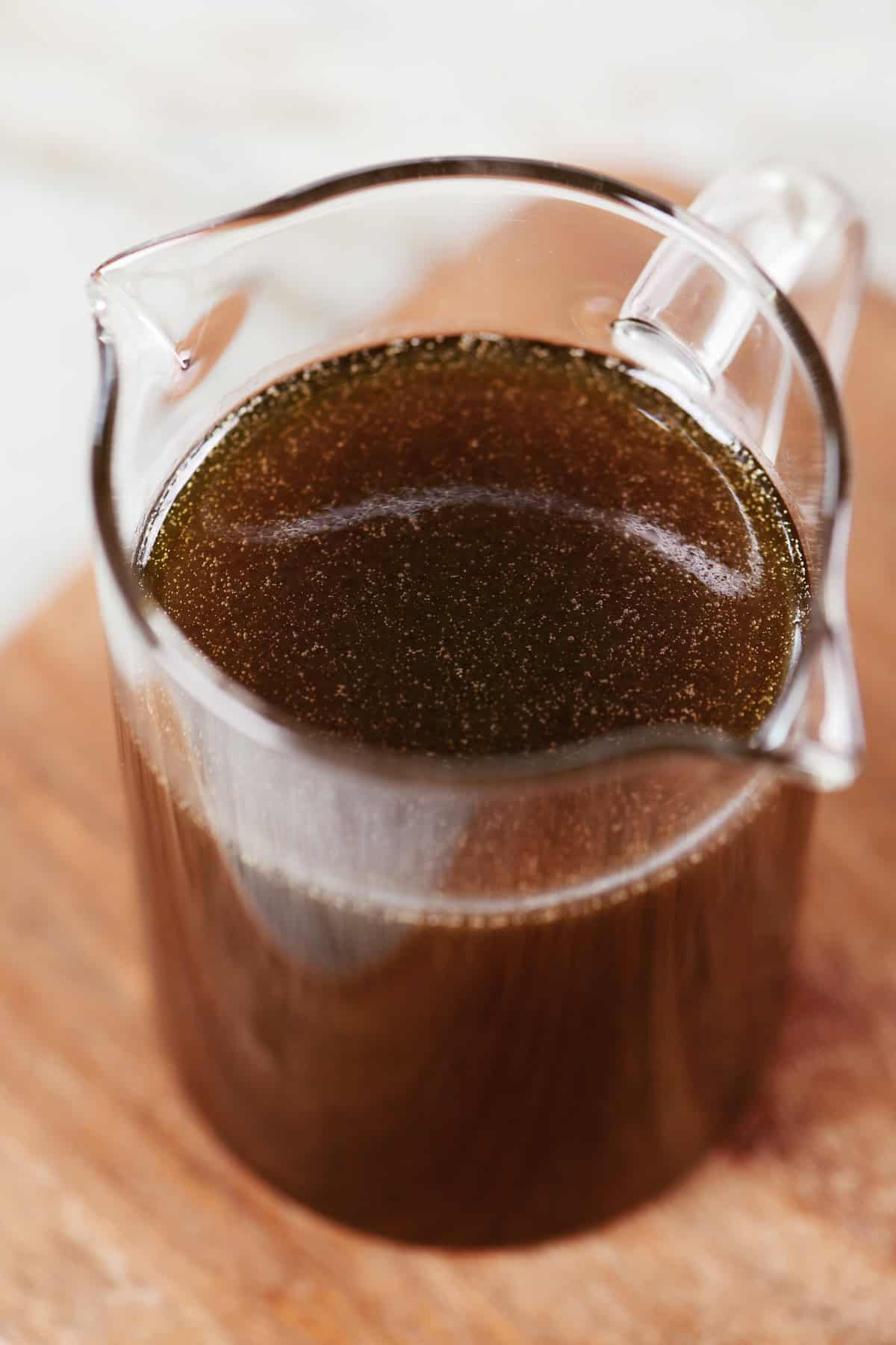 Homemade maple syrup in a glass pitcher.