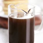 Homemade maple syrup in a glass pitcher.