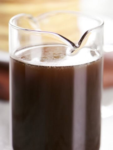 Homemade maple syrup in a glass pitcher.