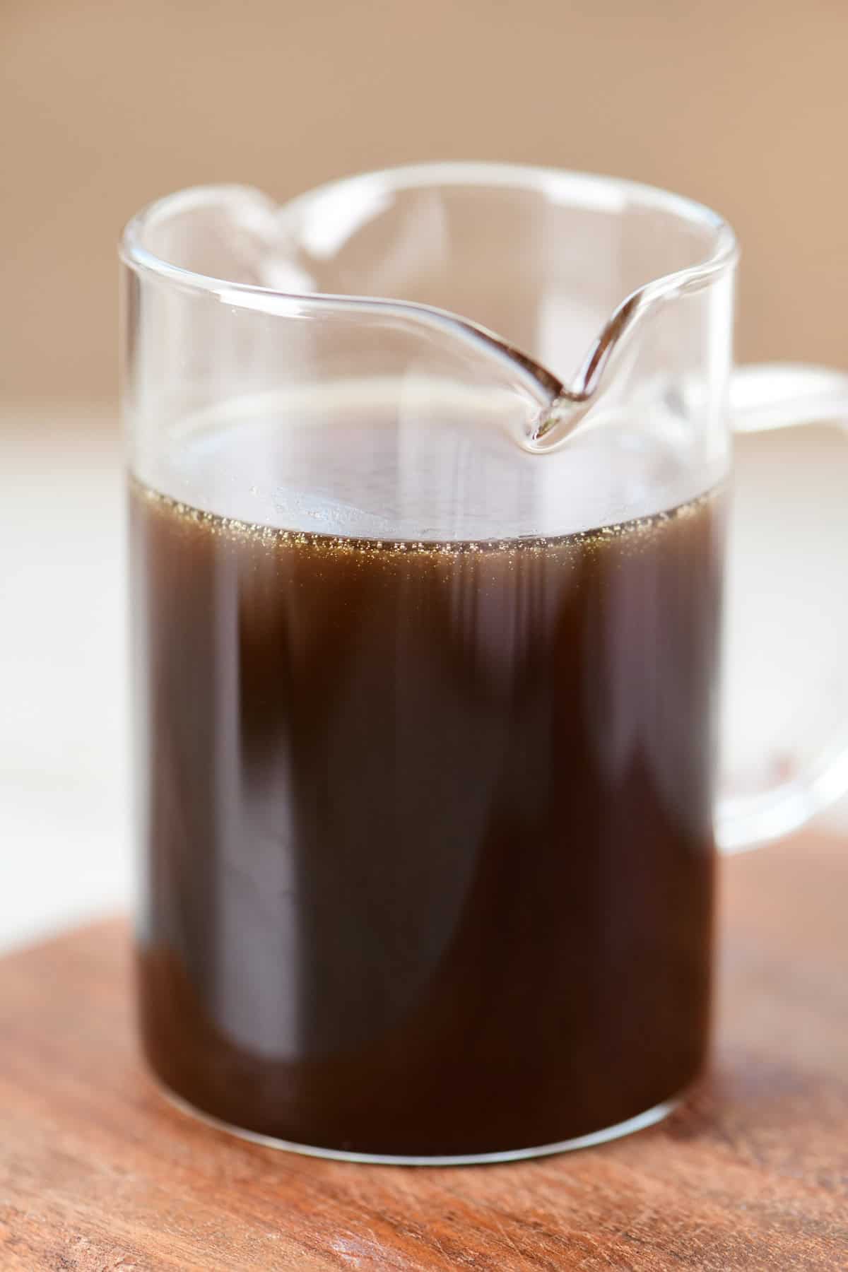 Homemade maple syrup in a glass pitcher.