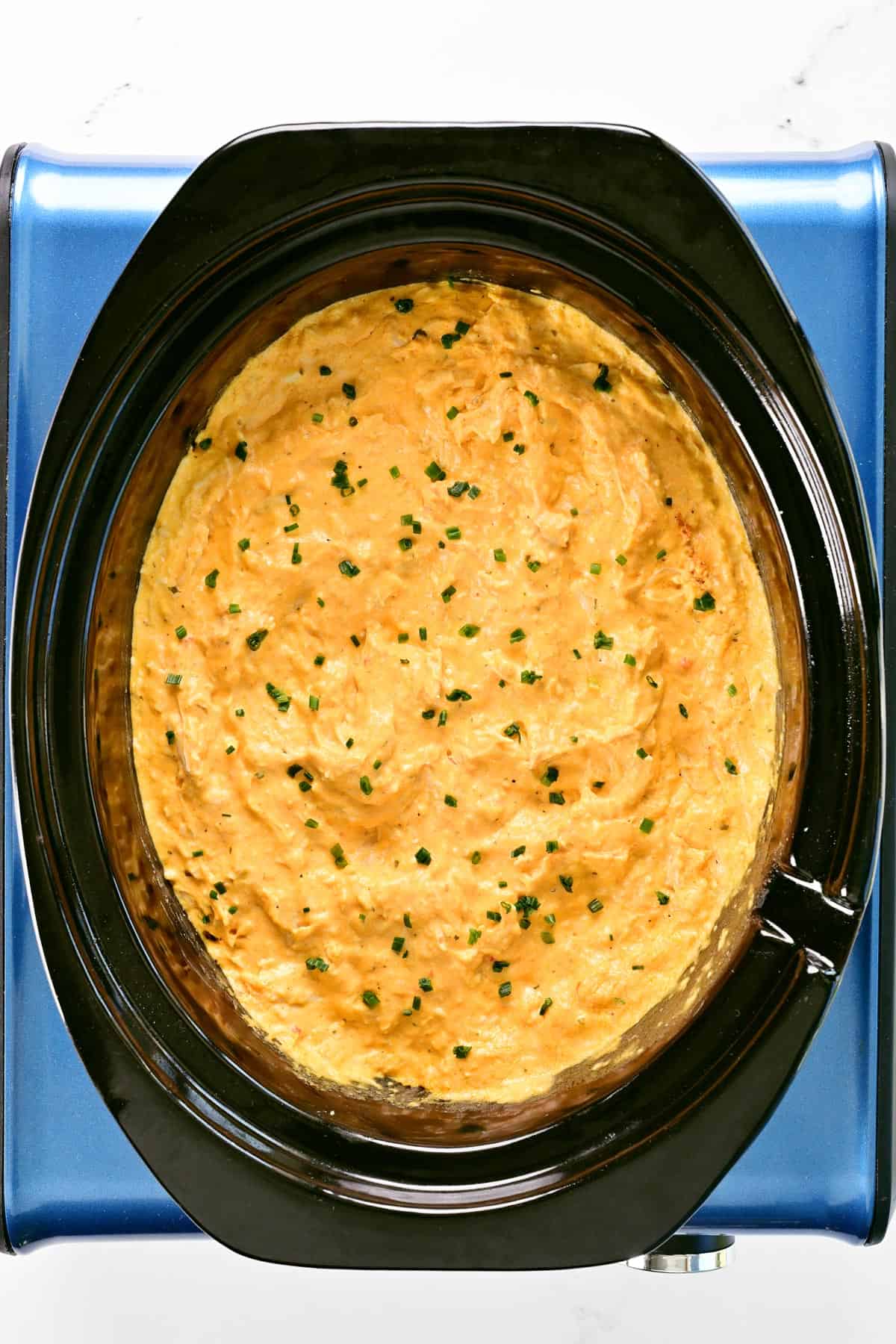 Buffalo chicken dip in a crockpot.