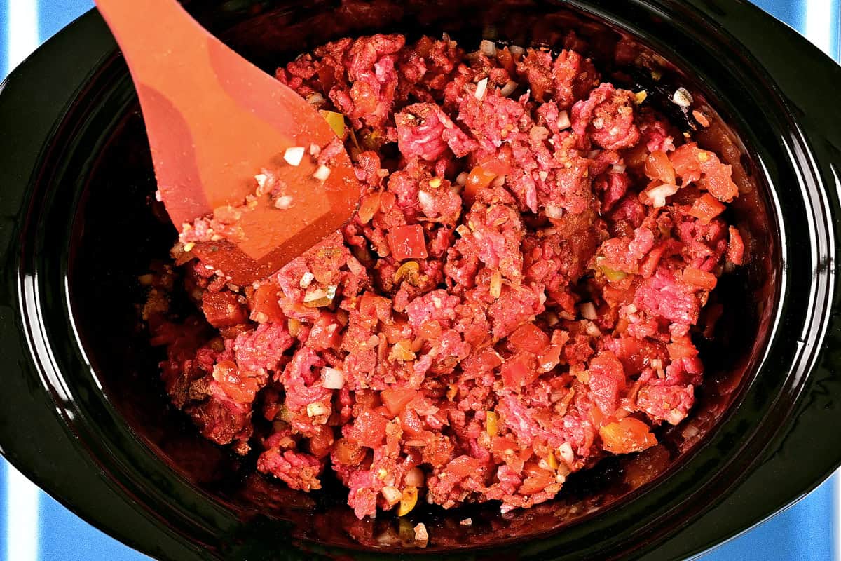 Ground beef and seasonings in a crockpot.