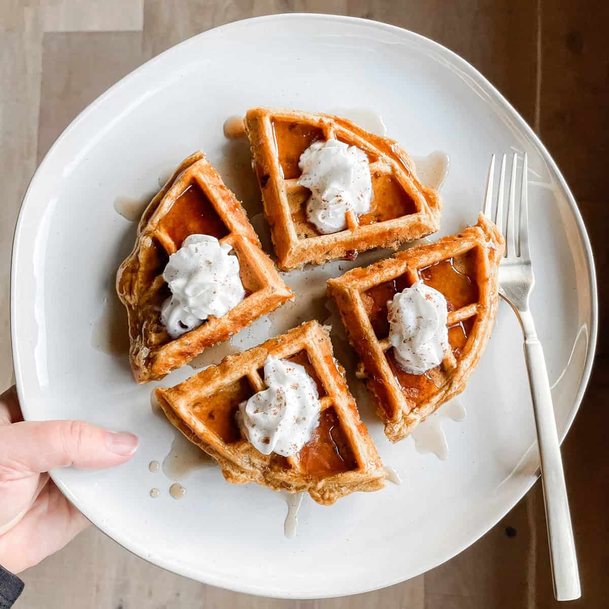 Tonia Larson holding a plate of pumpkin pecan waffles.