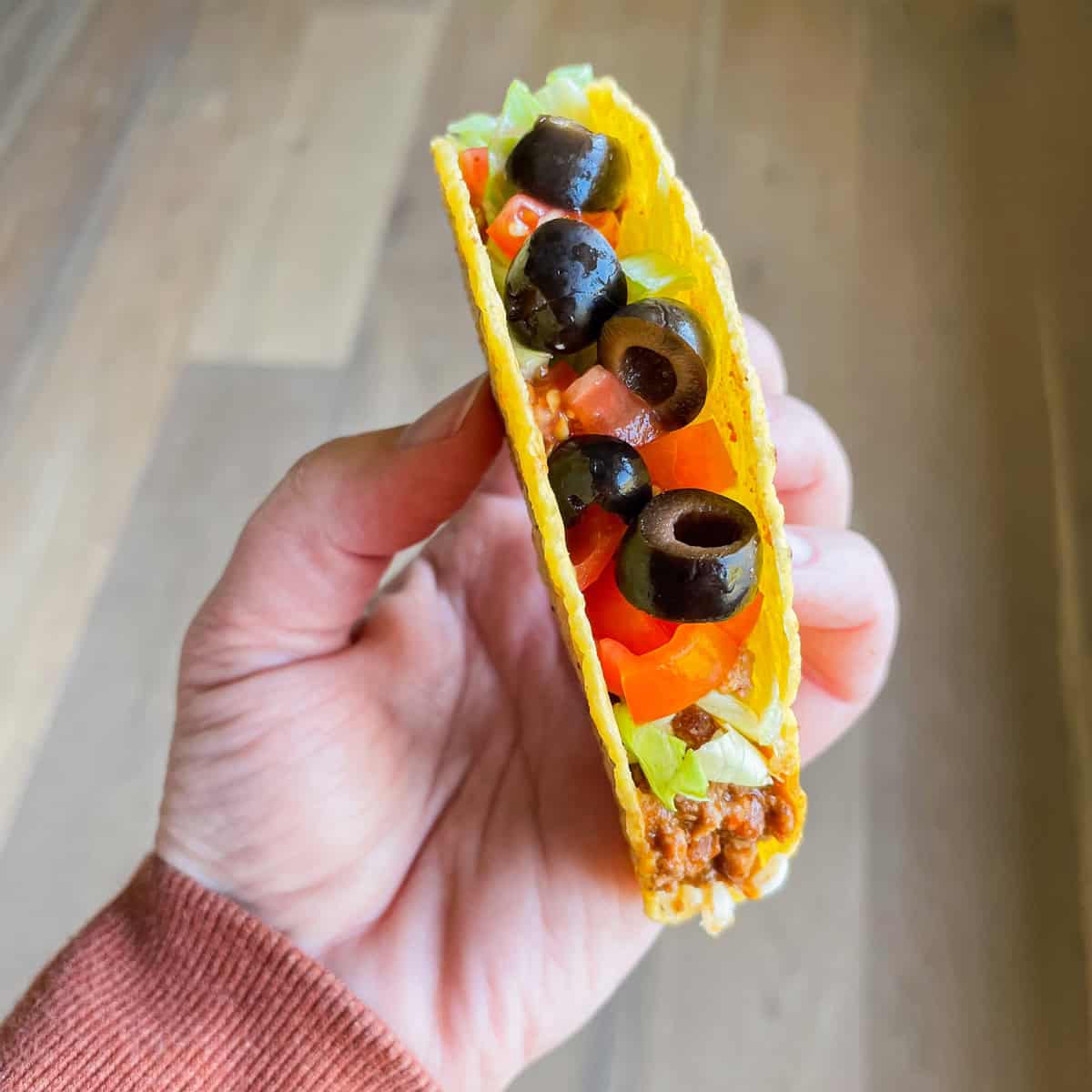 Tonia Larson holding a slow cooker taco.