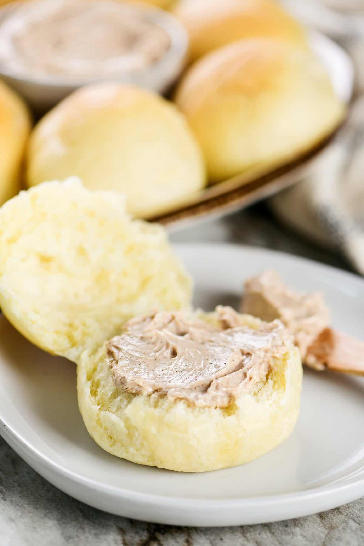 A dinner roll with cinnamon butter on top.