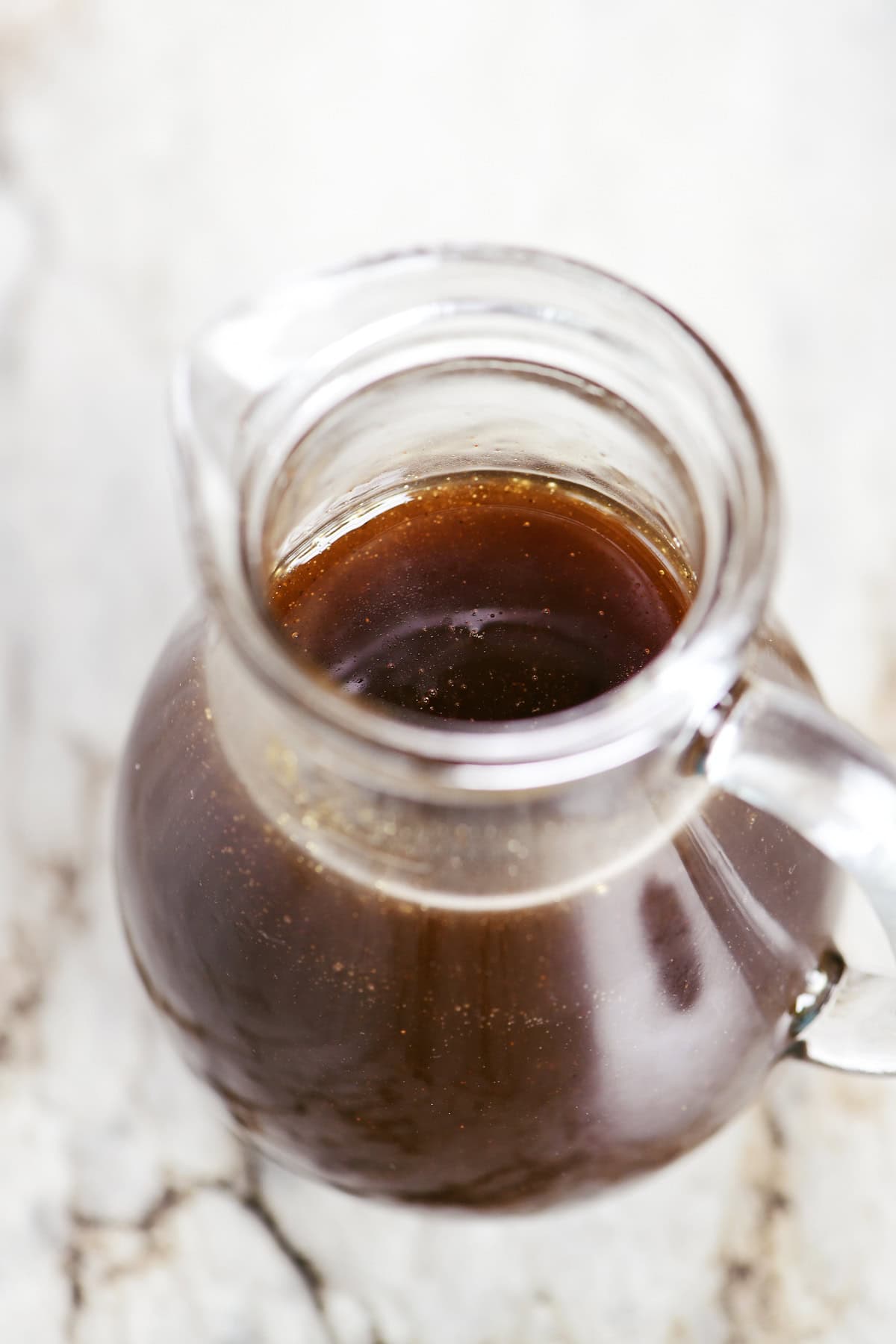 Looking into a pitcher of cinnamon syrup.