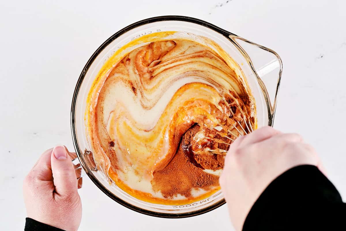 Whisking the batter in a glass bowl.