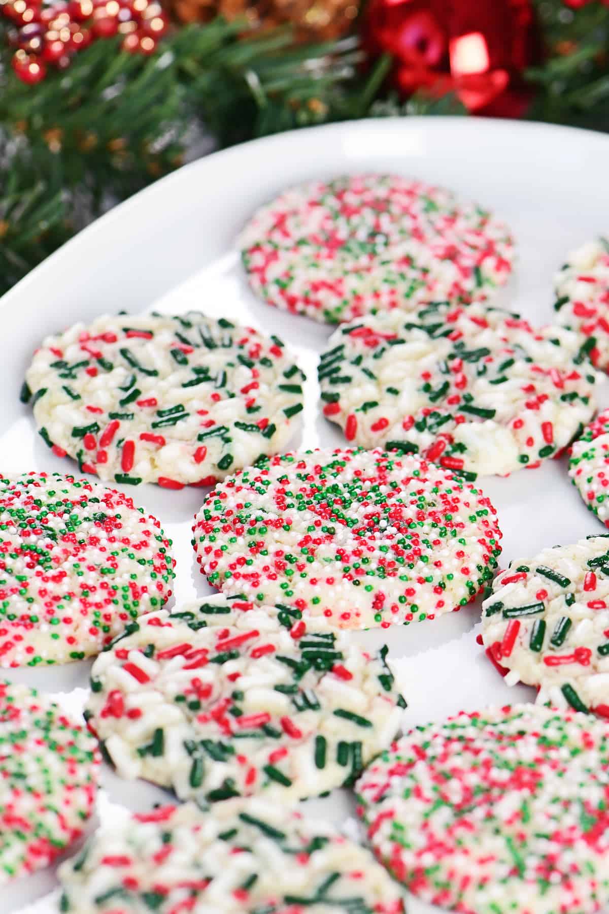 Christmas sprinkle sugar cookies on a tray.