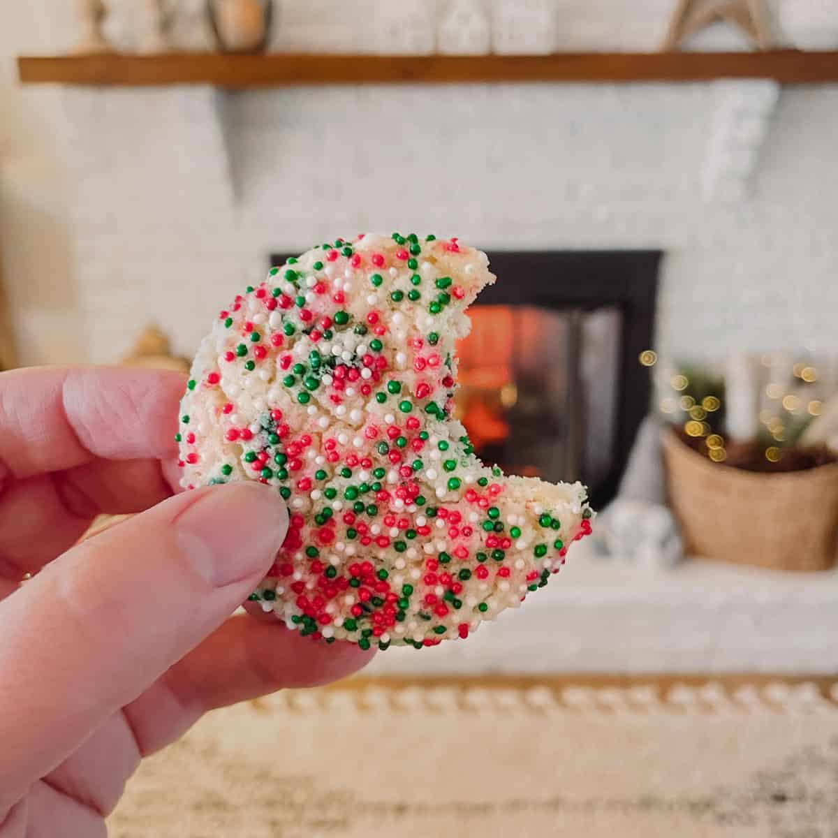 Tonia Larson holding a sprinkle sugar cookie.