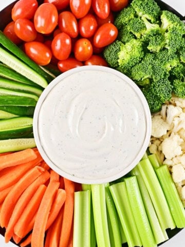 Cottage cheese ranch dip and veggies on a tray.