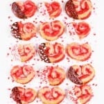 Puff pastry cookies heart shaped palmiers with chocolate and sprinkles.