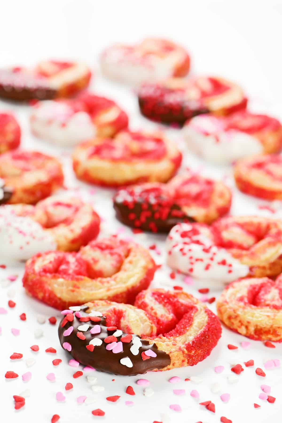 Puff pastry cookies that are heart shaped palmiers decorated for Valentine's Day.