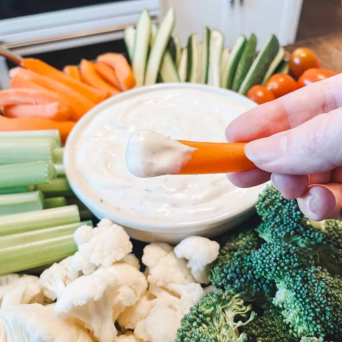 Cottage cheese ranch dip on a carrot.