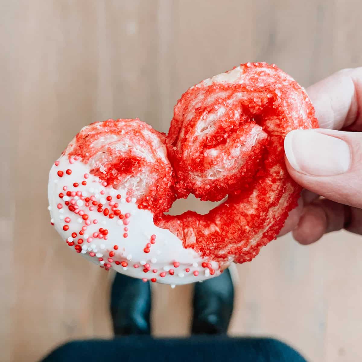 Tonia Larson holding a puff pastry cookie with sprinkles.