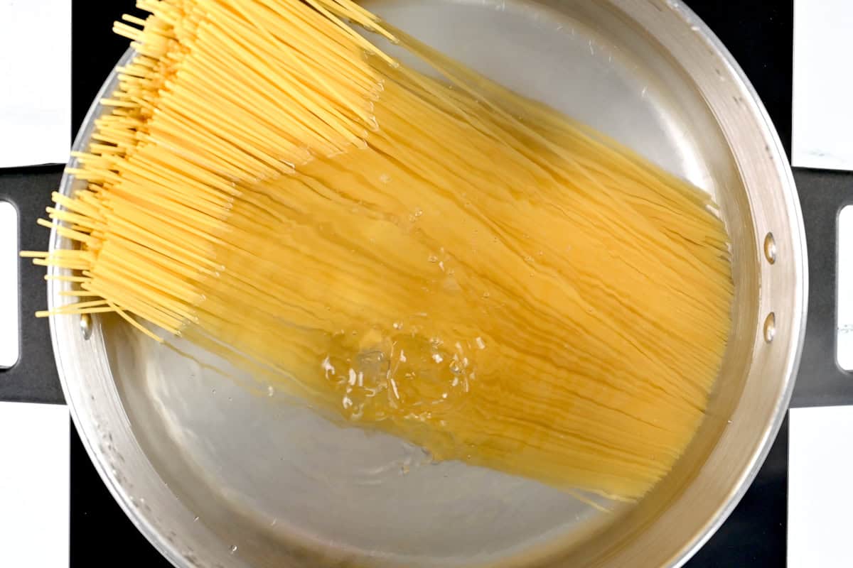 Angel hair pasta in a pot of boiling water.